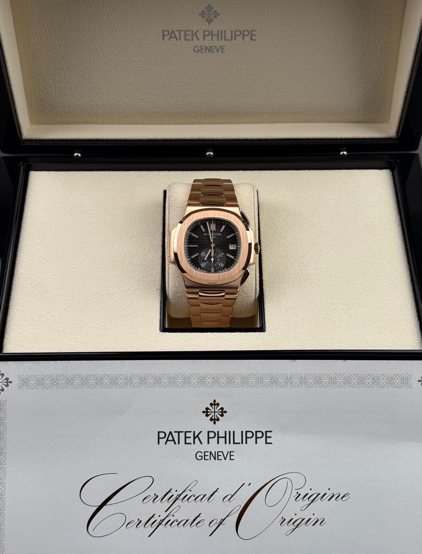 Rose gold sports chronograph with a black dial in its presentation box with certificate